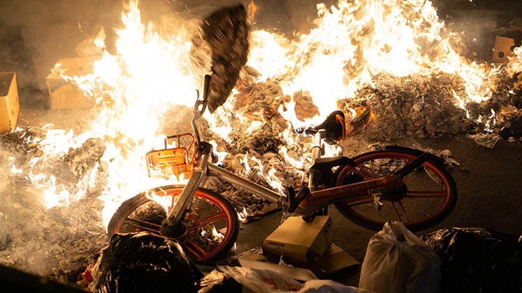 A bike burns on a barricade in Santiago during a protest