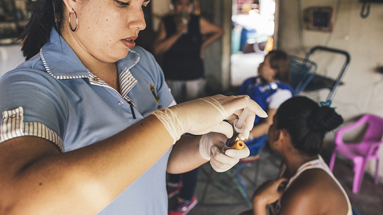 A nurse takes a blood sample in rural Colombia