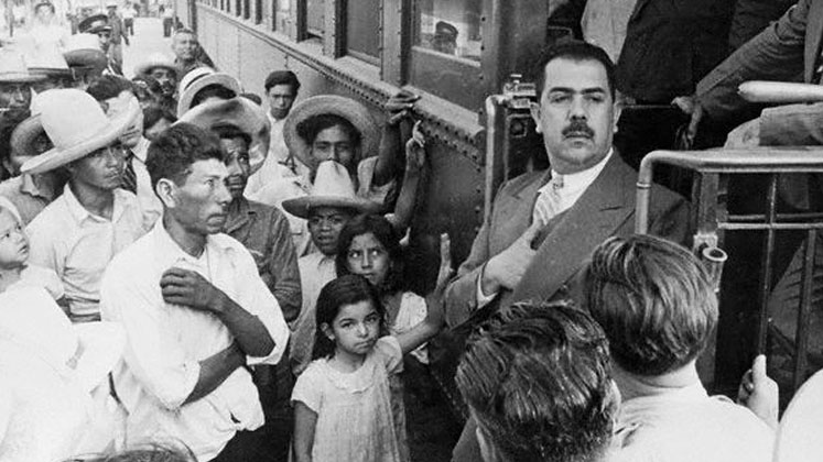President Lázaro Cárdenas stands on the steps of a railway carriage after nationalising foreign railways in 1937