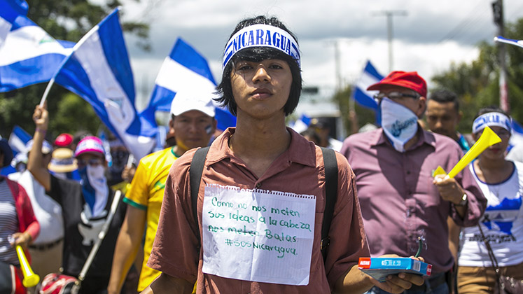 A young protester in Nicaragua looks into the camera defiantly during unrest in 2018