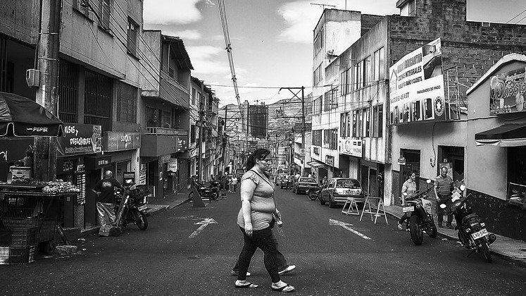 A woman passes by a street in Medellin