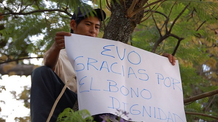 A man displays a banner showing support for Evo Morales