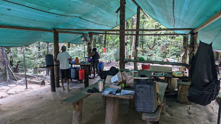 Two people inside a mining camp in the Amazon