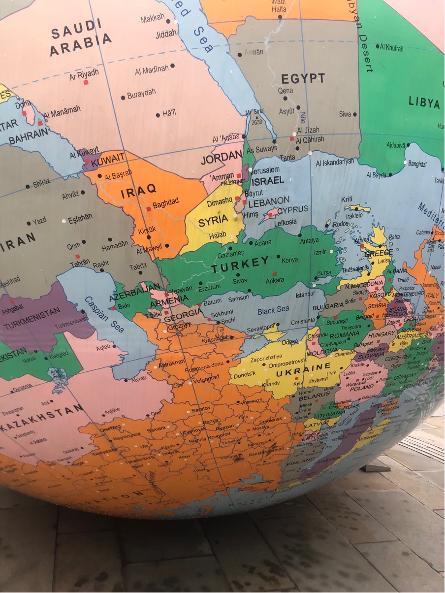 Image of The World Upside Down art work (a globe with the South Pole at the top) with a close up of Israel and Palestine
