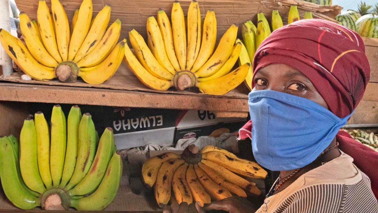 Woman wearing a face mask by her market stall