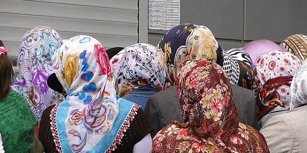 A number of Kurdish women in Turkey, pictured from behind, wearing colourful Hijab headscarves