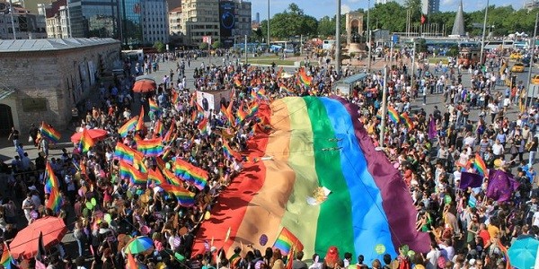 Crowd holding rainbow pride flags