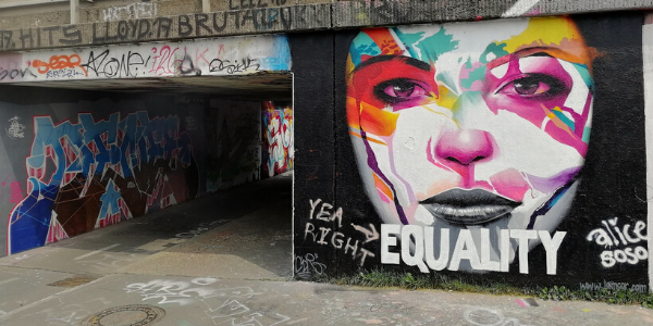 Street art image of woman's face with the word "Equality"