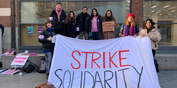 Photo of staff and students holding sign reading 'strike solidarity'