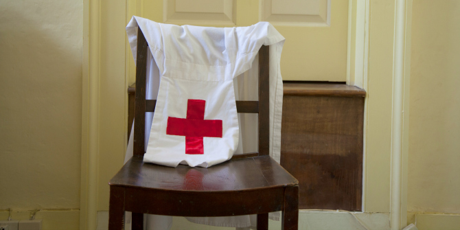 Nurse's uniform draped over a chair