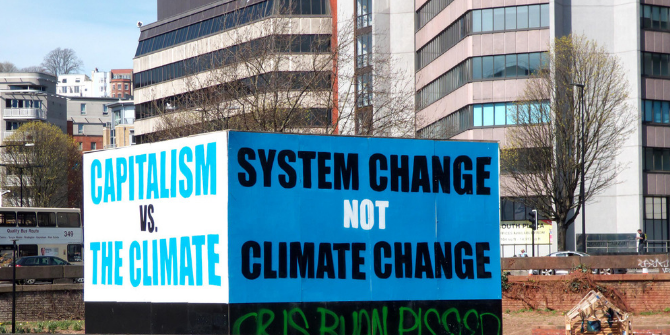 Sign reading 'System Change Not Climate Change'