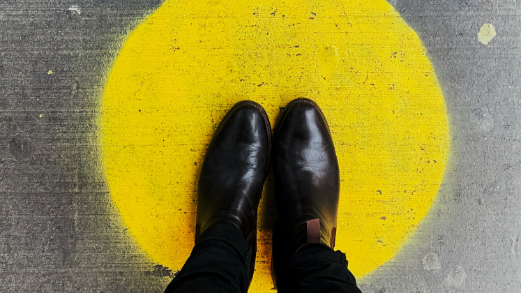 A pair of feet in the middle of a yellow circle