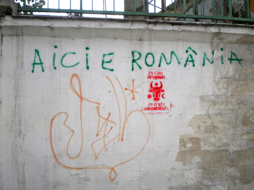 Here is Romania' (Latin script); 'I am Moldovan, I speak Moldovan' (Cyrillic script) on wall, Chișinău, Moldova, 2012