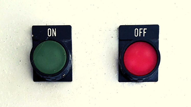 Green 'on' button on wall on left and red 'off' button on right