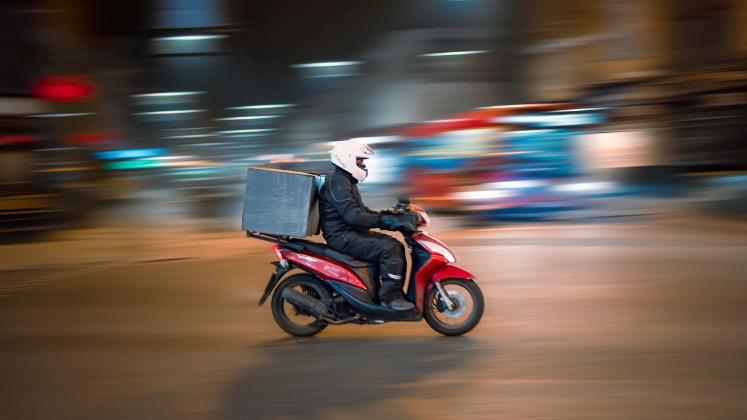 Person making delivery on motorbike