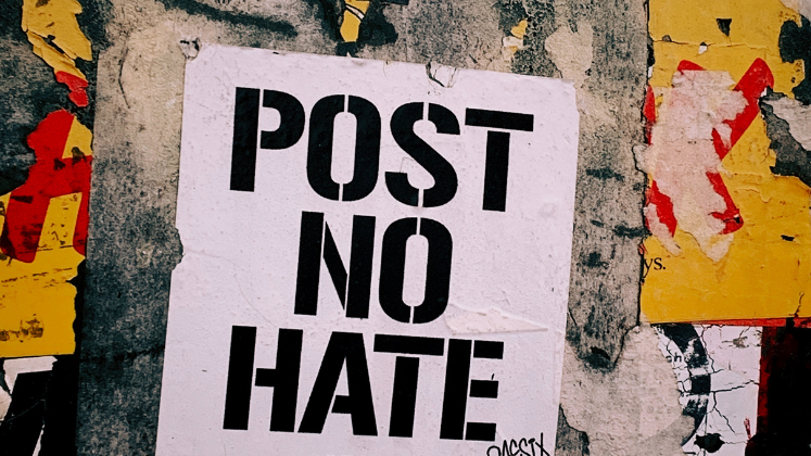 Sign on wall reading 'Post No Hate'