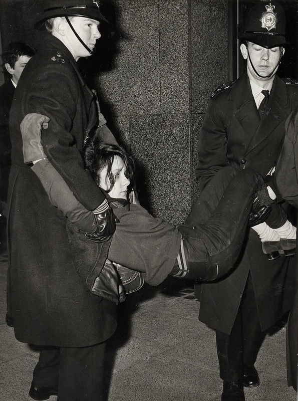A student protestor carried by police in the 1960s.