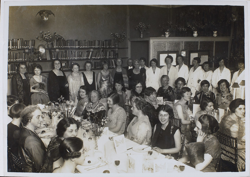 A large group of women gathered at tables for a dinner.