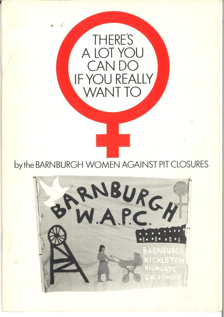 A paper with a red female symbol on with "There's a lot you can do if you really want to" written in the middle of it. Underneath is a WAPC banner and the name of the local group 'Barnburgh Women Against Pit Closures'.