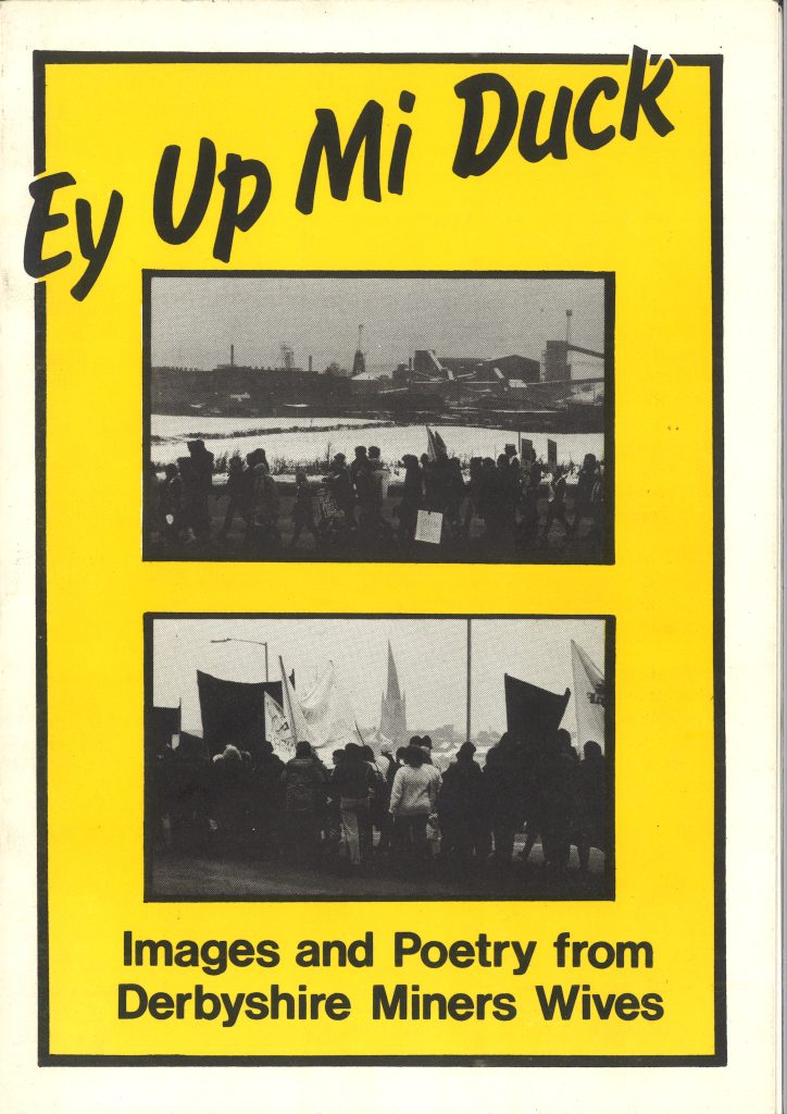 Front cover of an item. Yellow and black colour with two photos from the miners' strike. Text reads: "Ey Up Mi Duck. Images and Poetry from Derbyshire Miners Wives". 