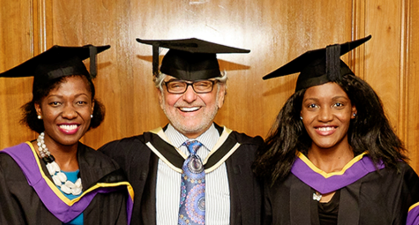 LSE graduation academic posing with two African graduates